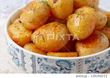 Baked new potatoes, with butter and dill, on a white plate, at home, no people, Baked new potatoes, with butter and dill, on a white plate, at home, no people, 126289215