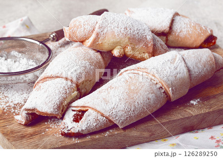 bagels with filling, sweet pastries, sprinkled with powdered sugar, on a wooden board, dessert, breakfast, bagels with filling, sweet pastries, sprinkled with powdered sugar, on a wooden board, dessert, breakfast, 126289250