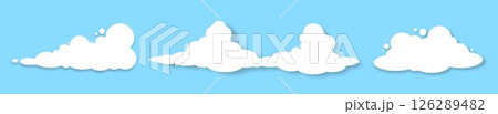 A set of three fluffy white clouds with a shadow on a blue background. 126289482