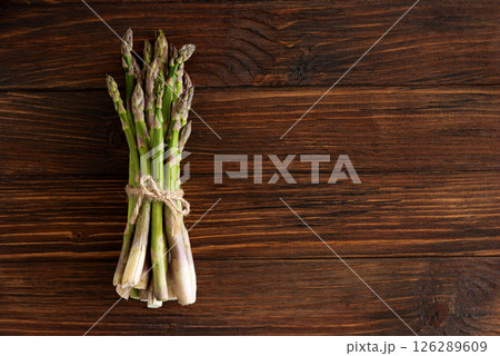 Asparagus tied bundle on rustic table. Top view Asparagus tied bundle on rustic table. Top view 126289609