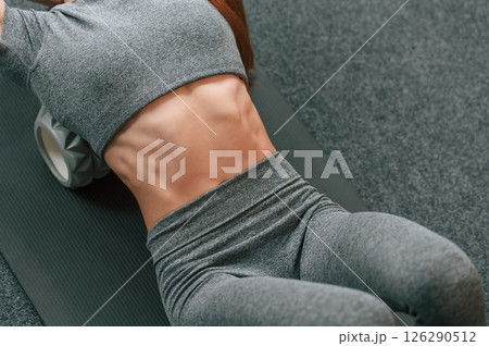 Close up view of the body. Young woman in yoga clothes doing fitness indoors 126290512