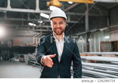 Giving the hand to shake. Manager in black formal wear at the factory 126290714