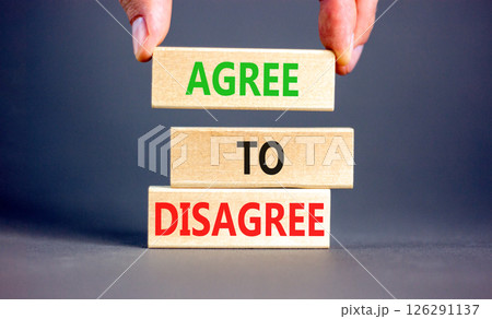 Agree to disagree symbol. Concept words Agree to disagree on beautiful wooden block. Businessman's hand. Beautiful grey background. Business and agree to disagree concept. Copy space. Agree to disagree symbol. Concept words Agree to disagree on beautiful wooden block. Businessman's hand. Beautiful grey background. Business and agree to disagree concept. Copy space. 126291137