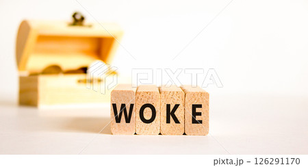 Woke question symbol. Concept word Woke question on beautiful wooden blocks. Chest with coins. Beautiful white table white background. Business, lifestyle, support woke question concept. Copy space. Woke question symbol. Concept word Woke question on beautiful wooden blocks. Chest with coins. Beautiful white table white background. Business, lifestyle, support woke question concept. Copy space. 126291170