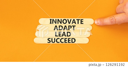 Innovate adapt lead succeed symbol. Concept words Innovate Adapt Lead Succeed on beautiful wooden sticks. Beautiful orange background. Business innovate adapt lead succeed concept. Copy space. 126291192