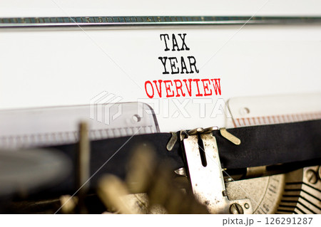 Tax year overview symbol. Concept words Tax year overview typed on beautiful old retro vintage typewriter. Beautiful white background. Business tax year overview concept. Copy space. Tax year overview symbol. Concept words Tax year overview typed on beautiful old retro vintage typewriter. Beautiful white background. Business tax year overview concept. Copy space. 126291287