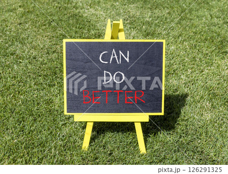 Can do better symbol. Concept words Can do better on beautiful yellow blackboard. Beautiful green grass lawn background. Business and can do better concept. Copy space. 126291325