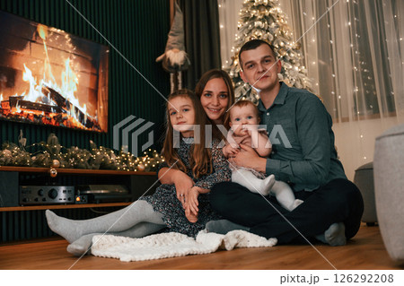 Happy family is sitting together at home. Celebrating New Year Happy family is sitting together at home. Celebrating New Year 126292208