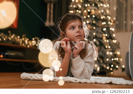 Portrait of little girl that is at home celebrating new year Portrait of little girl that is at home celebrating new year 126292213