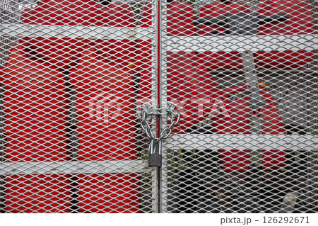 Locked Security Gate Protecting Red Gas Tanks 126292671