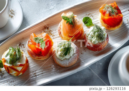 Party snacks with smoked salmon, soft cheese and herbs 126293116