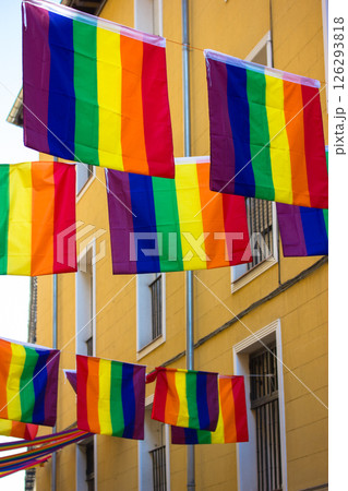 Colorful rainbow flags are strung across a street, decorating city for celebrating the pride month. Diversity of lgbtq community. Love is love concept Colorful rainbow flags are strung across a street, decorating city for celebrating the pride month. Diversity of lgbtq community. Love is love concept 126293818