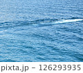The texture of waves in the sea and ocean. Background, pattern with blue, blue water with a wave. Nature, reservoir. Waves and foam from ships, boats, speedboats and yachts. Hiking and surfing 126293935
