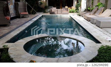 Serene Private Villa Pool with Lounge Chairs and Jacuzzi Offering a Relaxing Tropical Getaway Surrounded by Lush Greenery Serene Private Villa Pool with Lounge Chairs and Jacuzzi Offering a Relaxing Tropical Getaway Surrounded by Lush Greenery 126294090