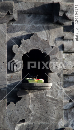 Balinese Stone Shrine with Traditional Offering in Morning Light at a Local Temple Balinese Stone Shrine with Traditional Offering in Morning Light at a Local Temple 126294172