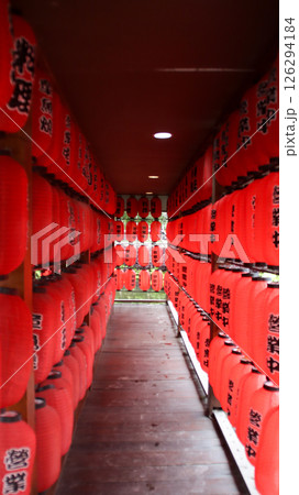 Vibrant Corridor of Red Lanterns Inside a Traditional Asian Building with a Wooden Floor and Symmetrical Pattern 126294184
