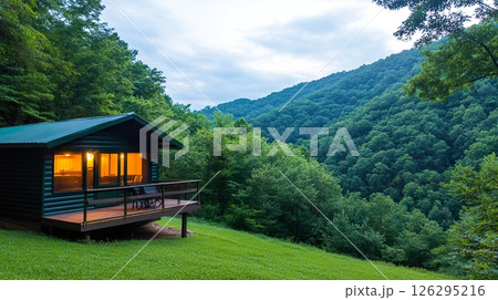 Cozy Cabin with Scenic Mountain View in Lush Forested Landscape at Dusk. 126295216