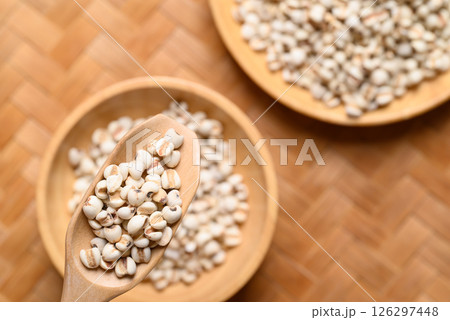 Dried Job's tears or adlay millet seeds in wooden scoop with bowl, Food ingredient, Top view 126297448