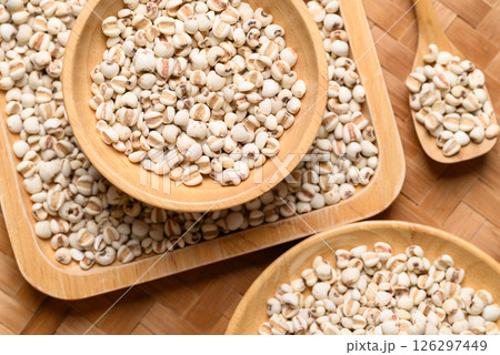 Dried Job's tears or adlay millet seeds in wooden bowl with spoon, Food ingredient, Top view Dried Job's tears or adlay millet seeds in wooden bowl with spoon, Food ingredient, Top view 126297449
