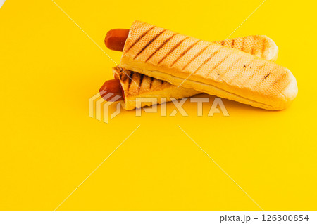 Delicious hot dogs served in crispy waffle cones on yellow Delicious hot dogs served in crispy waffle cones on yellow 126300854