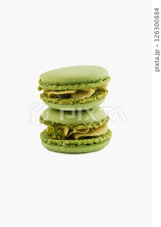 Green macarons stacked on a white background 126300884