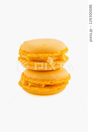 Bright yellow macarons stacked on top of each other Bright yellow macarons stacked on top of each other 126300886