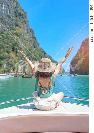 Woman tourist on boat trip, happy traveller relaxing at Pileh lagoon on Phi Phi island, Krabi, Thailand. Exotic landmark, destination Southeast Asia Travel, summer vacation and holiday concept Woman tourist on boat trip, happy traveller relaxing at Pileh lagoon on Phi Phi island, Krabi, Thailand. Exotic landmark, destination Southeast Asia Travel, summer vacation and holiday concept 126301394