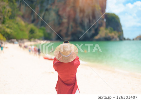 Woman tourist travel and sightseeing in Krabi, Thailand. happy traveller enjoy on beach at Phra nang Cave Beach near Railay Beach. summer trip, destination, Southeast Asia Travel and vacation concept Woman tourist travel and sightseeing in Krabi, Thailand. happy traveller enjoy on beach at Phra nang Cave Beach near Railay Beach. summer trip, destination, Southeast Asia Travel and vacation concept 126301407