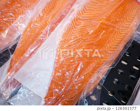 Salmon fillet in a vacuum package plastic bag. Salmon fillet in a vacuum package plastic bag. 126301577