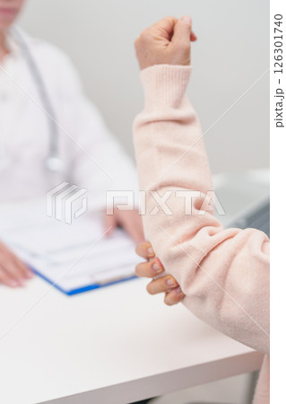 Elderly Woman having elbow ache and consulting doctor in hospital. muscle pain due to lateral epicondylitis or tennis elbow. injury, Health and medical consultation concept Elderly Woman having elbow ache and consulting doctor in hospital. muscle pain due to lateral epicondylitis or tennis elbow. injury, Health and medical consultation concept 126301740