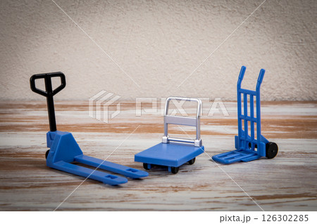 Miniature warehouse equipment on a wooden texture background 126302285