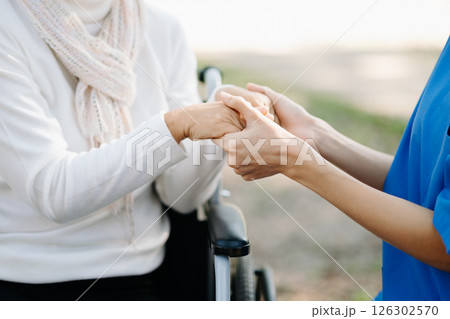 female hands touching senior male hand Helping hands take care of the elderly concept 126302570
