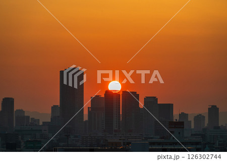 大阪弁天町駅周辺ビルから望む日の出（5月撮影）　 126302744