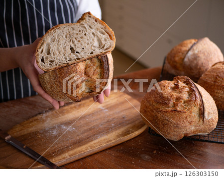Baker Hand Presenting Homemade Sourdough. 126303150