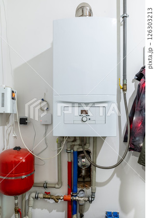 Wall-mounted gas boiler in a private house Wall-mounted gas boiler in a private house 126303213