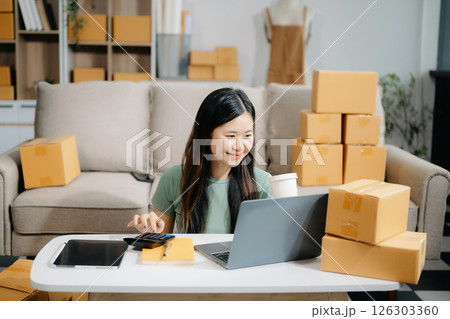 Startup small business SME, Entrepreneur owner woman using smartphone or tablet taking receive and checking online purchase shopping orde Startup small business SME, Entrepreneur owner woman using smartphone or tablet taking receive and checking online purchase shopping orde 126303360