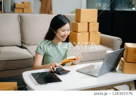 Startup small business SME, Entrepreneur owner woman using smartphone or tablet taking receive and checking online purchase shopping orde Startup small business SME, Entrepreneur owner woman using smartphone or tablet taking receive and checking online purchase shopping orde 126303376