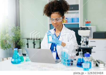 female scientist working with micro pipettes analyzing biochemical samples, advanced science chemical laboratory female scientist working with micro pipettes analyzing biochemical samples, advanced science chemical laboratory 126303484