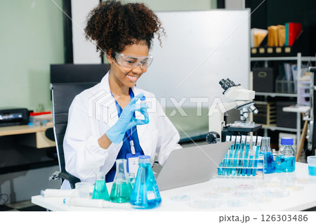 female scientist working with micro pipettes analyzing biochemical samples, advanced science chemical laboratory female scientist working with micro pipettes analyzing biochemical samples, advanced science chemical laboratory 126303486
