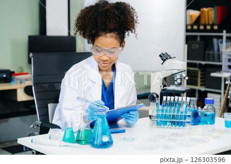 female scientist working with micro pipettes analyzing biochemical samples, advanced science chemical laboratory 126303596