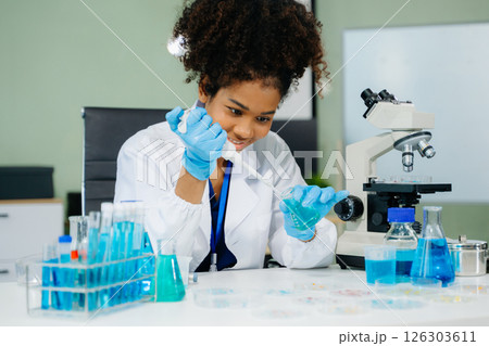 Young scientists conducting research investigations in a medical laboratory, a researcher in the foreground 126303611