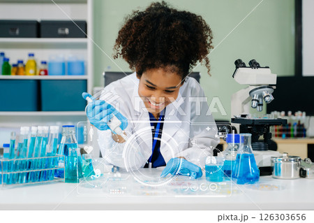 Young scientists conducting research investigations in a medical laboratory, a researcher in the foreground Young scientists conducting research investigations in a medical laboratory, a researcher in the foreground 126303656