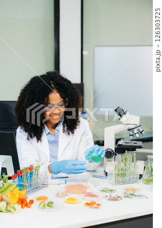 Food science as lab scientists test and analyze vegetables for safety and quality using advanced technology 126303725