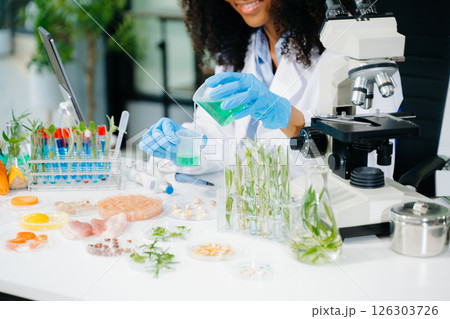 Food science as lab scientists test and analyze vegetables for safety and quality using advanced technology 126303726