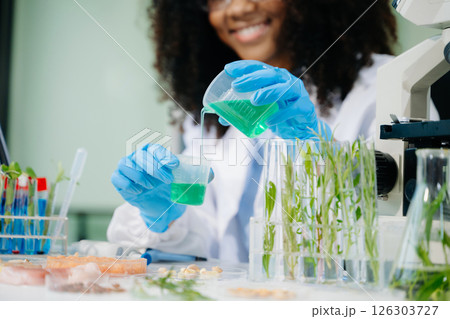 Food science as lab scientists test and analyze vegetables for safety and quality using advanced technology 126303727