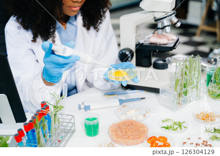Food science as lab scientists test and analyze vegetables for safety and quality using advanced technology Food science as lab scientists test and analyze vegetables for safety and quality using advanced technology 126304129