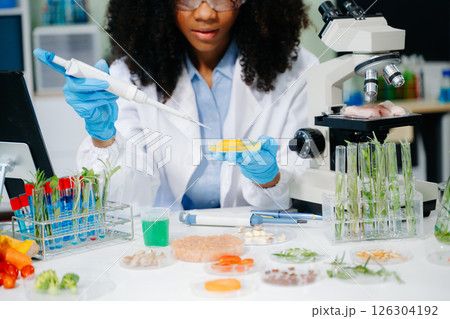 Food science as lab scientists test and analyze vegetables for safety and quality using advanced technology 126304192