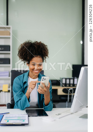 Young beautiful woman using laptop and tablet while sitting at her working place. Young beautiful woman using laptop and tablet while sitting at her working place. 126304216