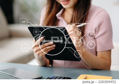 Person who attends online lessons on a virtual screen tablet. E-learning education and online webinar. Education internet Technology. Person who attends online lessons on a virtual screen tablet. E-learning education and online webinar. Education internet Technology. 126304452