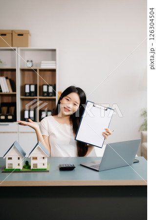 Considering buying a home, investing in real estate. Broker signs a sales agreement. agent, lease agreement, successful deal Considering buying a home, investing in real estate. Broker signs a sales agreement. agent, lease agreement, successful deal 126304504